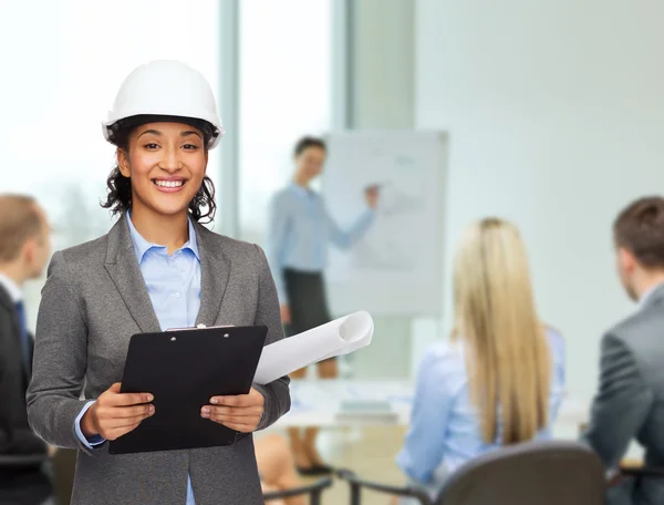 Businesswoman in white helmet with clipboard — Stock Photo, Image