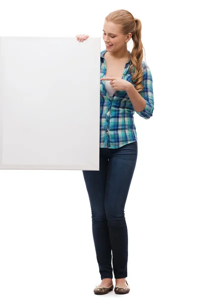 Smiling young woman with white blank board — Stock Photo, Image