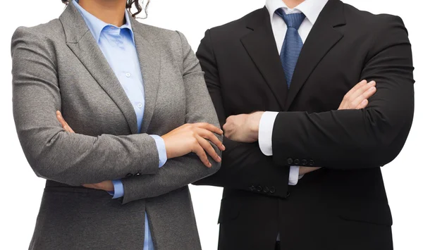 Businesswoman and businessman with crossed arms — Stock Photo, Image