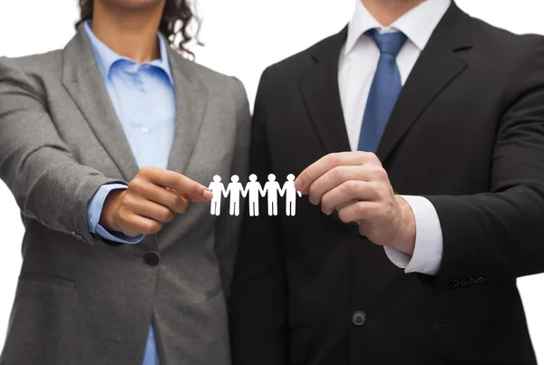 Businessman and businesswoman holding paper team — Stock Photo, Image