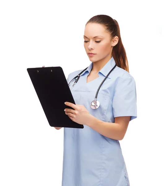 Serious female doctor or nurse with stethoscope — Stock Photo, Image