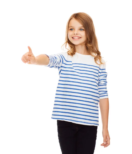 Cute girl pointing in the air or virtual screen — Stock Photo, Image