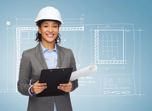 Businesswoman in white helmet with clipboard — Stock Photo, Image