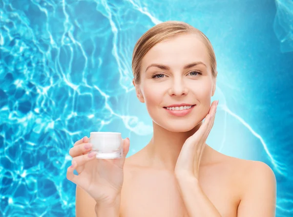 Woman applying cream on her skin — Stock Photo, Image