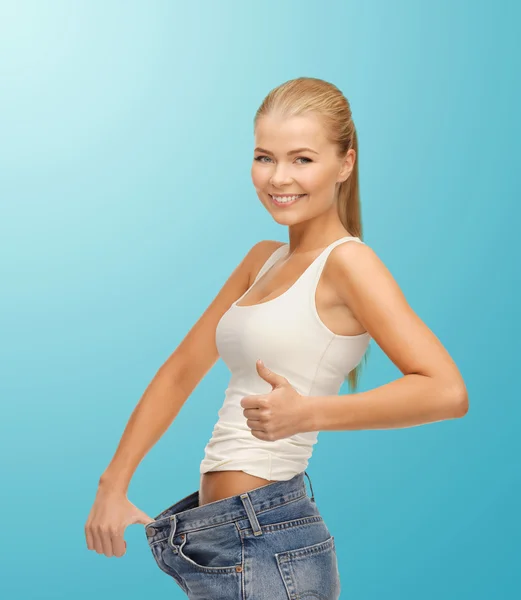 Sporty woman showing big pants — Stock Photo, Image