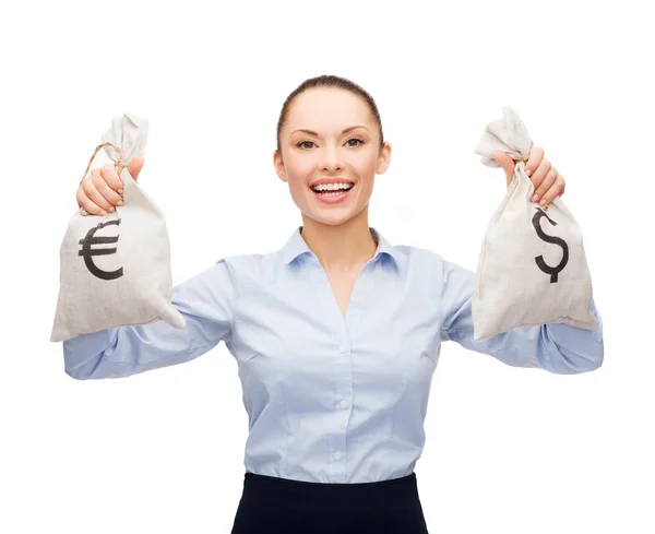 Businesswoman holding bags with dollar and euro — Stock Photo, Image