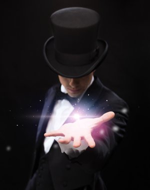 Magician holding something on palm of his hand clipart
