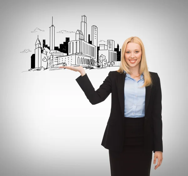 Smiling woman showing city sketch on her hand — Stock Photo, Image