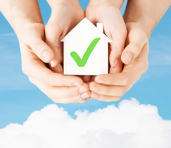 Hands holding house with check mark — Stock Photo, Image