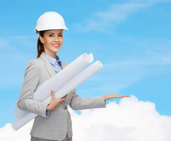 Smiling architect in white helmet with blueprints — Stock Photo, Image