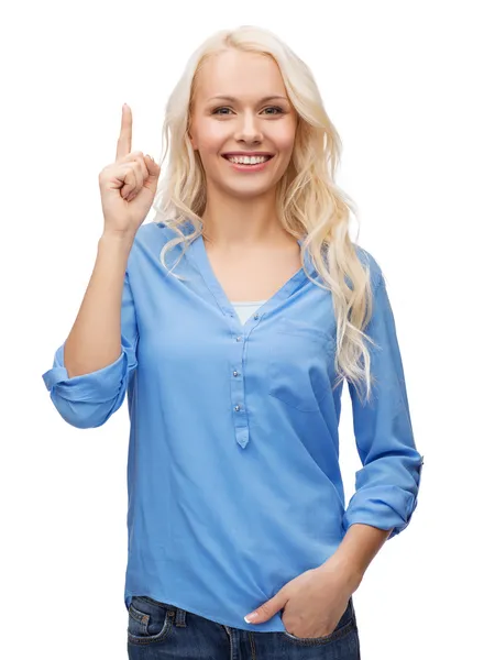 Attractive young woman pointing her finger up — Stock Photo, Image