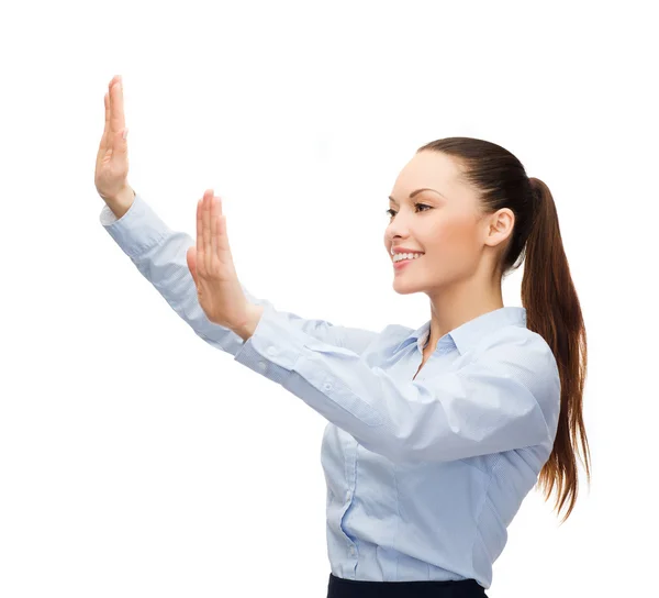 Smiling businesswoman pointing to something — Stock Photo, Image