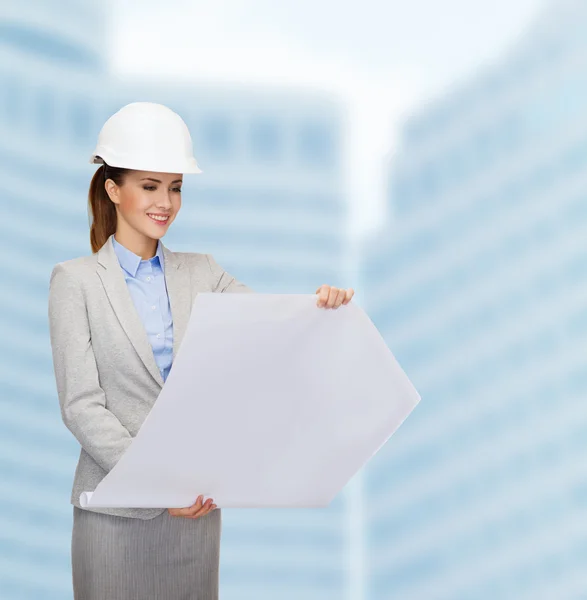 Smiling architect in white helmet with blueprints — Stock Photo, Image