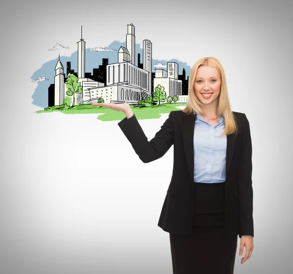 Smiling woman showing city sketch on her hand — Stock Photo, Image