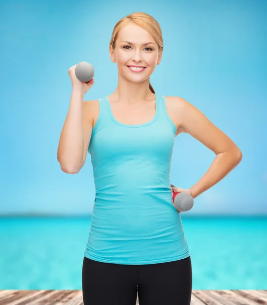 Joven mujer deportiva con pesas ligeras —  Fotos de Stock