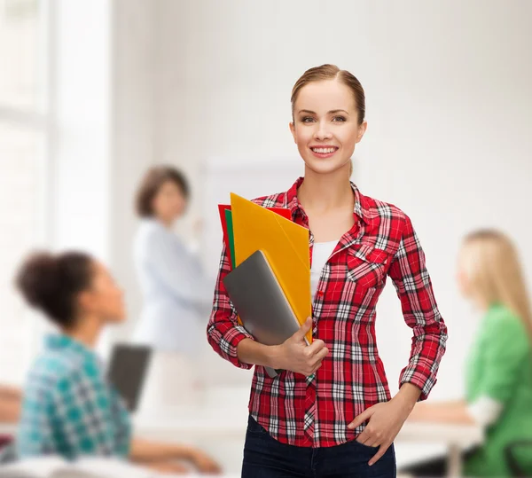 Smiling student with folders and tablet pc — Stock Photo, Image