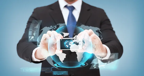 Businessman showing smartphone with globe hologram — Stock Photo, Image