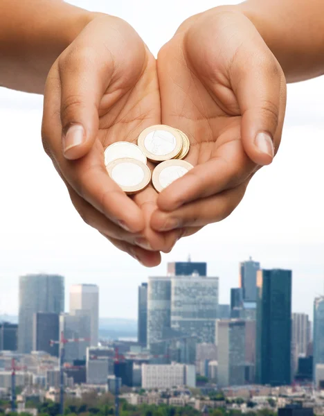 Womans cupped hands showing euro coins — Stock Photo, Image