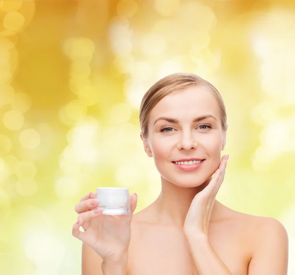 Woman applying cream on her skin — Stock Photo, Image