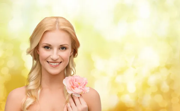 Smiling woman with peony flower Royalty Free Stock Images