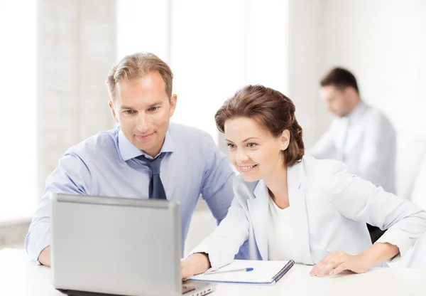 Homem e mulher trabalhando com laptop no escritório — Fotografia de Stock