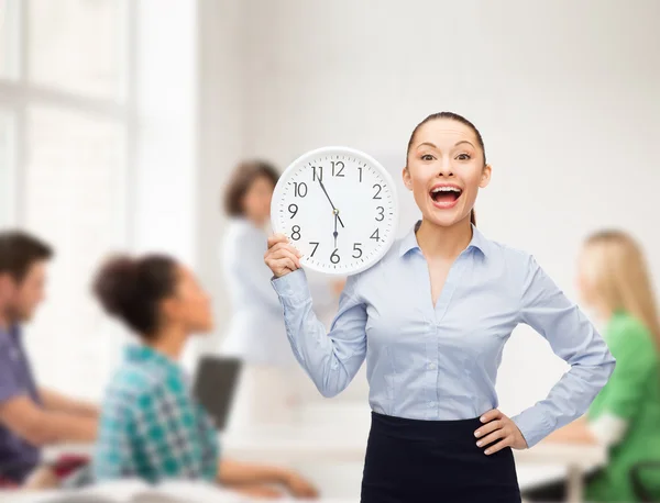 Attractive teacher with wall clock — Stock Photo, Image