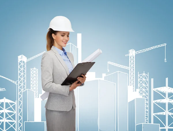 Smiling architect in white helmet with blueprints — Stock Photo, Image