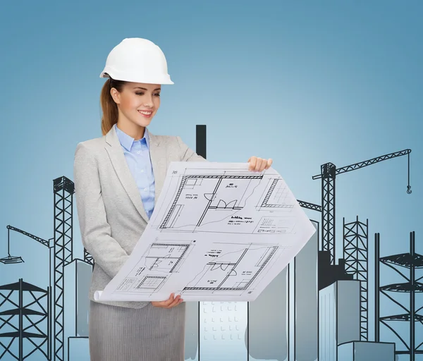 Smiling architect in white helmet with blueprints — Stock Photo, Image