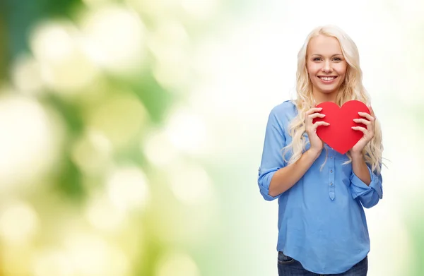 Smiling woman with red heart — Stock Photo, Image