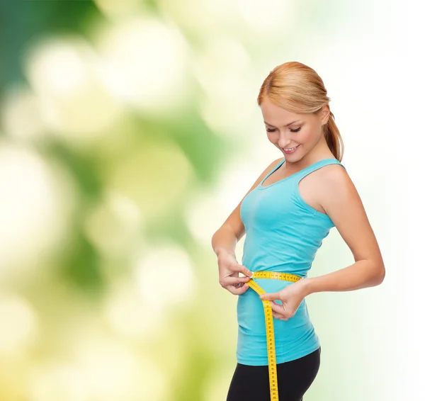 Sporty woman with measuring tape — Stock Photo, Image