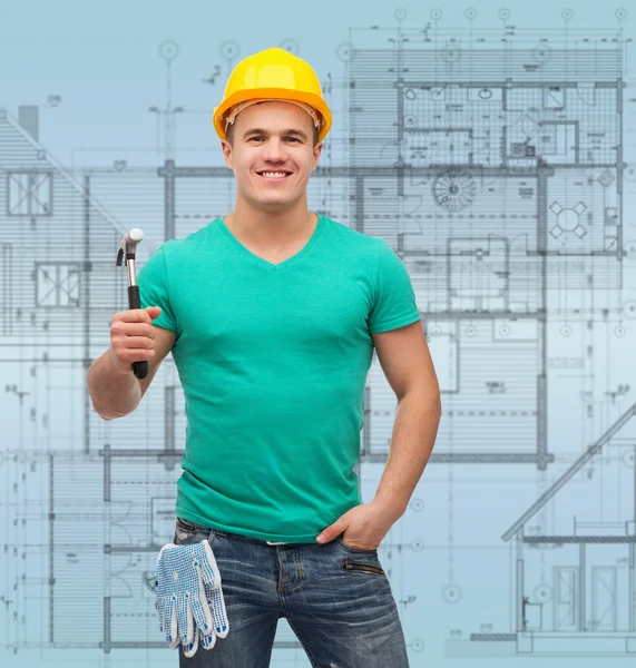 Smiling manual worker in helmet with hammer — Stock Photo, Image