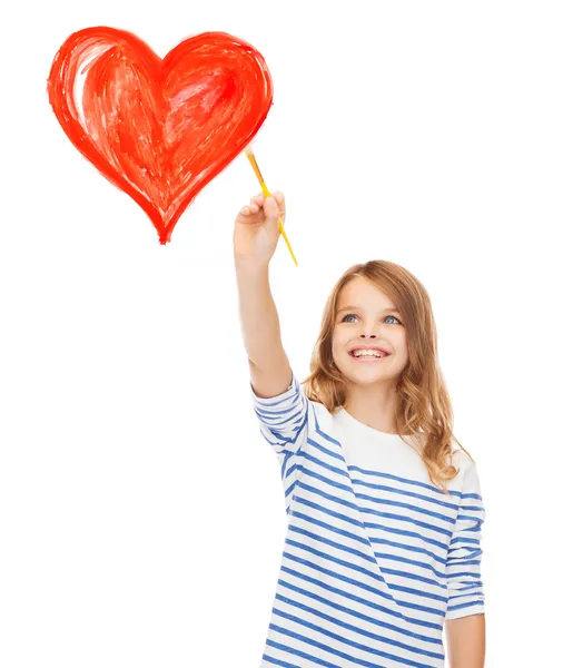 Cute little girl drawing heart with brush — Stock Photo, Image