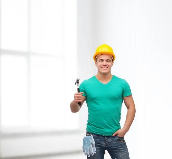 Smiling manual worker in helmet with hammer — Stock Photo, Image