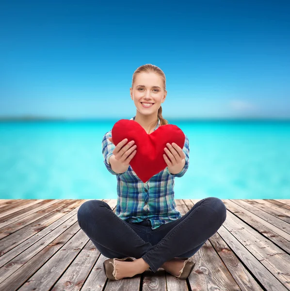 Young woman in casual clothes sitting on floor — Stock Photo, Image