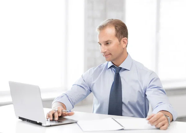 Miling businessman working in office Stock Picture