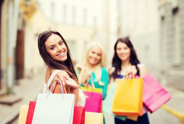 Girls with shopping bags in city clipart