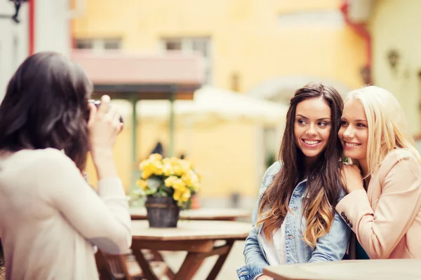 Beautiful girls taking picture in cafe in city — Stock Photo, Image