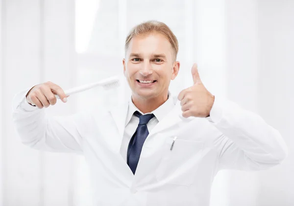 Dentist with toothbrush in hospital — Stock Photo, Image