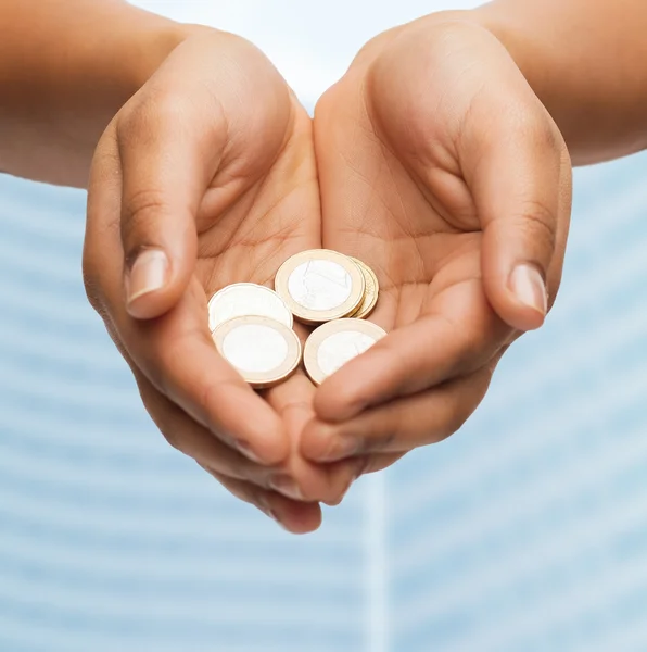 Womans cupped hands showing euro coins — Stock Photo, Image