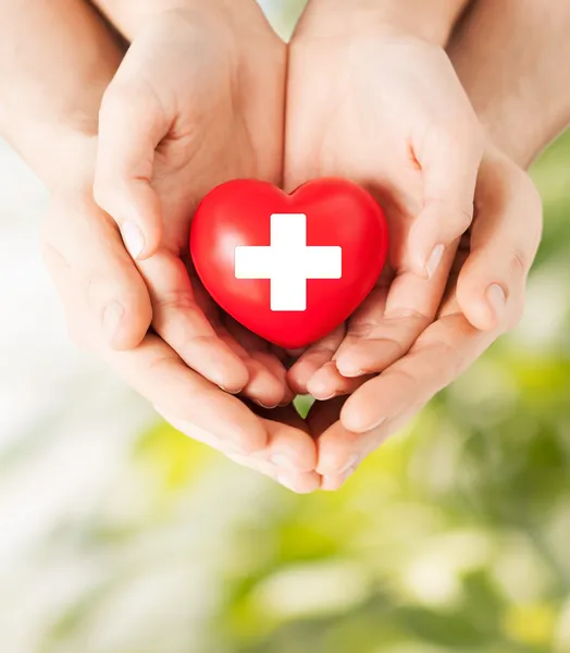 Male and female hands with red heart — Stock Photo, Image