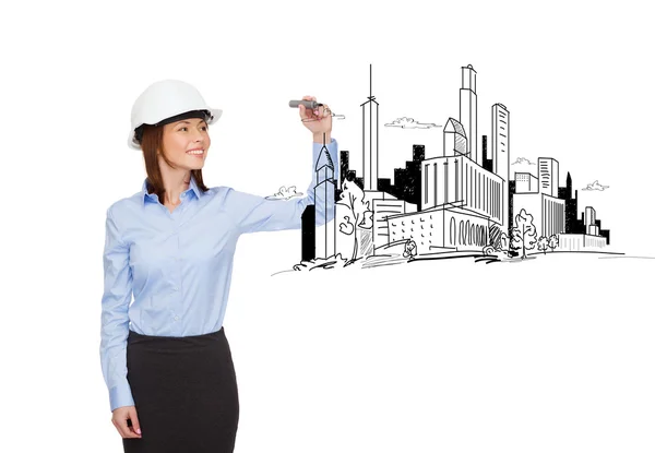 Businesswoman in helmet writing on virtual screen — Stock Photo, Image