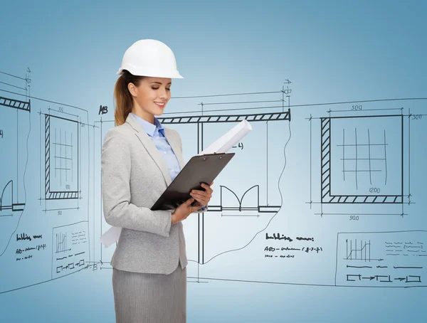 Smiling architect in white helmet with blueprints — Stock Photo, Image