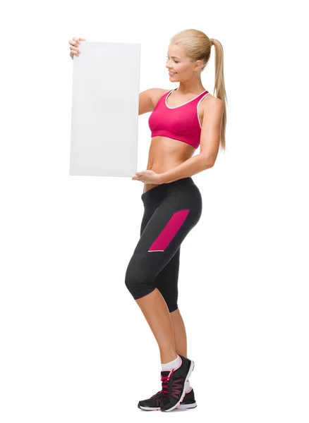 Sportswoman with white blank board — Stock Photo, Image