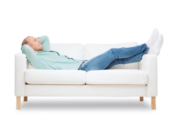 Smiling man lying on sofa — Stock Photo, Image