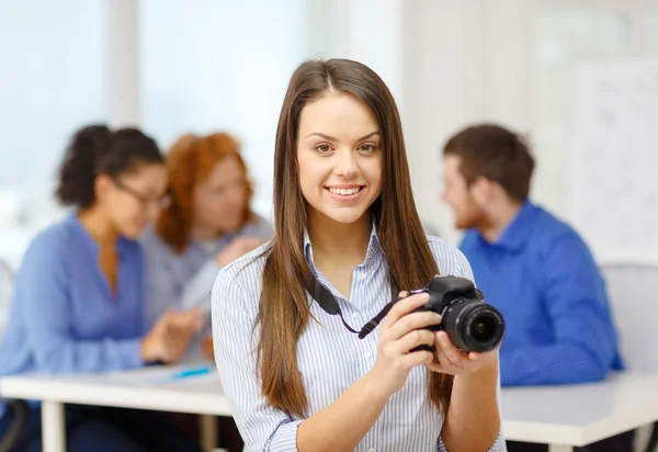 Smiling female photographer with photocamera — Stock Photo, Image