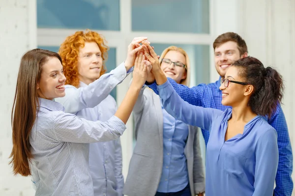 Creative team doing high five gesture in office — Stock Photo, Image