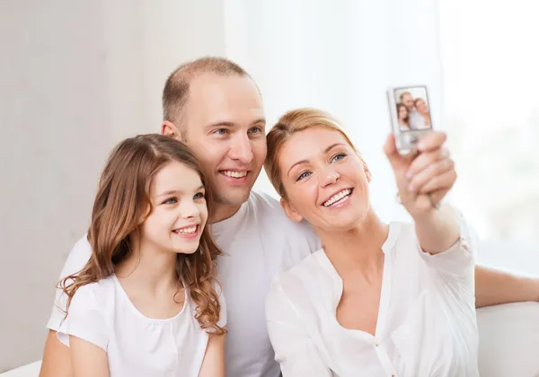 Happy family with little girl making self portrait — Stock Photo, Image