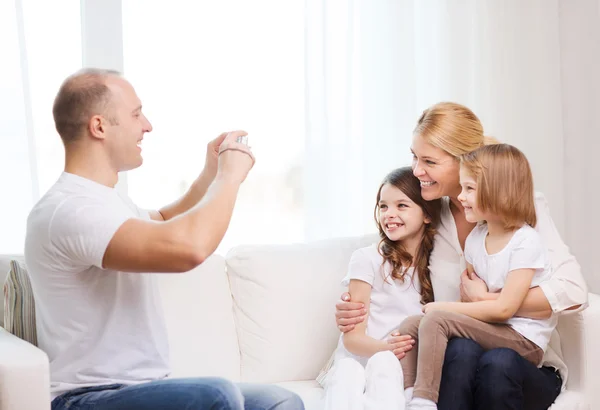 Father taking picture of mother and daughters — Stock Photo, Image