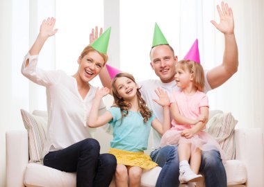Happy family with two kids in hats celebrating clipart