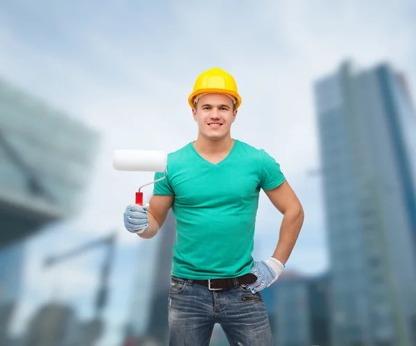 Gülen boya silindiri ile kask içinde işçi — Stok fotoğraf